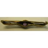 A gold brooch set with large central amethyst