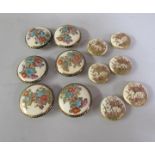 Two Meiji period sets of six Satsuma costume buttons, one set decorated with flowers (one slightly