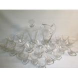 A 1920's Bohemian clear crystal cocktail set engraved with horizontal and vertical blocked lines,