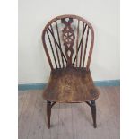 A 19c Windsor single chair with yew wood hooped spindle back with wheel carved splat on a shaped elm