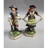 A pair of Derby figures being a musician playing a flute and a lady dancing, each supported on