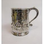 A late Georgian silver tankard, London 1812 with later embossing and chasing with flowers and scroll