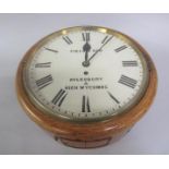 An early 20c oak wall time piece, the white enamel circular dial with Roman numerals and signed
