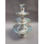 A Minton three tier cake stand, the pierced blue borders reserved with floral sprays and highlighted