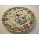 A 19c Chinese famille rose plate decorated with leaf and flowers with an outer flowering border,