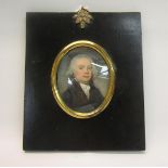 An early 19c oval portrait miniature on ivory of a gentleman, framed, 7cm x 5.5cm.