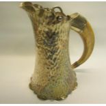 A late Victorian silver plated ale jug of beaten tapering spreading form with hinge cover and