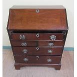 A George III small proportion mahogany bureau with fall front and fitted interior over two short and