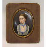 A 19c framed oval portrait miniature of a lady, she wearing a crucifix and blue bow, framed, 9.5cm x