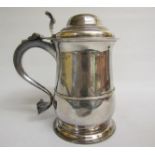 A mid Georgian tankard with scrolling handle and thumb piece, having a heart shaped base terminal