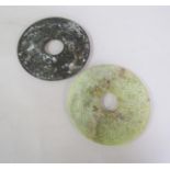 Two 19c Oriental circular plaques, one of green stone, the other onyx, green stone carved with