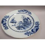 A Delft plate painted with figures and Oriental pagodas, the border with three groups of peonies and