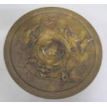 A 19c bronze circular dish supported on four legs, incised Kain. The dish embossed and chased with a