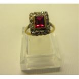 A 18ct yellow gold ring set with central rectangular ruby surrounded by diamonds. Approx ring size