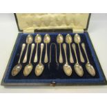 A boxed set of twelve silver teaspoons together with a pair of tongs, Sheffield 1825.