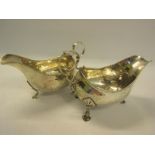 A pair of Georgian style Irish silver sauce boats with double scroll handles and supported on