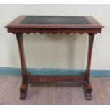 A Victorian mahogany reading table of rectangular form with a shaped frieze on a stretcher frame