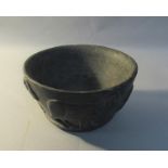 A Middle Eastern 15c bowl, black glazed with continual border of incised high relief rams, 13cm