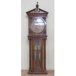 A late 19c Royal Polytechnic Barometer by Davis & Co in oak case with broken arch pediment with
