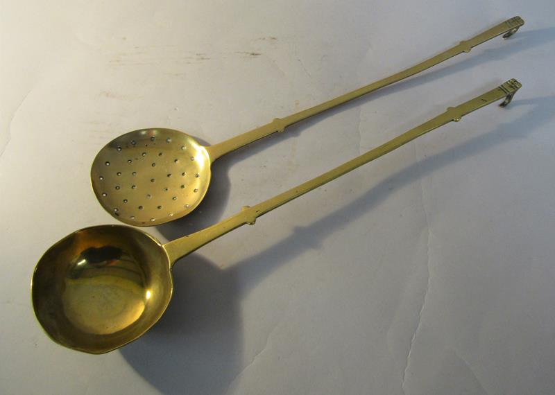 An early 19c brass ladle together with a skimmer, both 45cm l.