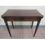A late 19c/early 20c Gillows figured walnut fold over card table, baise lined and with corner wells,