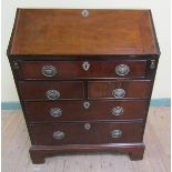 A George III figured mahogany bureau with fall front and fitted interior over two short and three