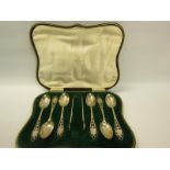 A set of six silver teaspoons together with a pair of tongs, the teaspoons with pierced