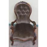 A Walnut carved show frame upholstered cameo back open armchair.