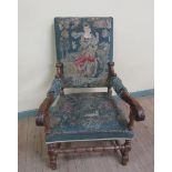 An early 18c style walnut framed upholstered open armchair with leaf carved scrolling arms on turned