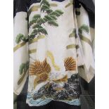 A Japanese child's silk Kimono in shades of cream, black and gold, decorated with trees and a sea