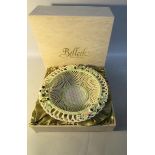A Belleek lattice ware bowl encrusted with berries, leaf and blossom with brown factory mark to