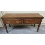 A late 18c oak two drawer dresser base with a hinged fold over top supported on square tapering