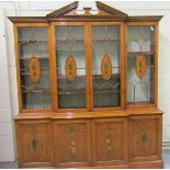 A Regency style satin wood breakfront library bookcase, painted with flower and tendrils,