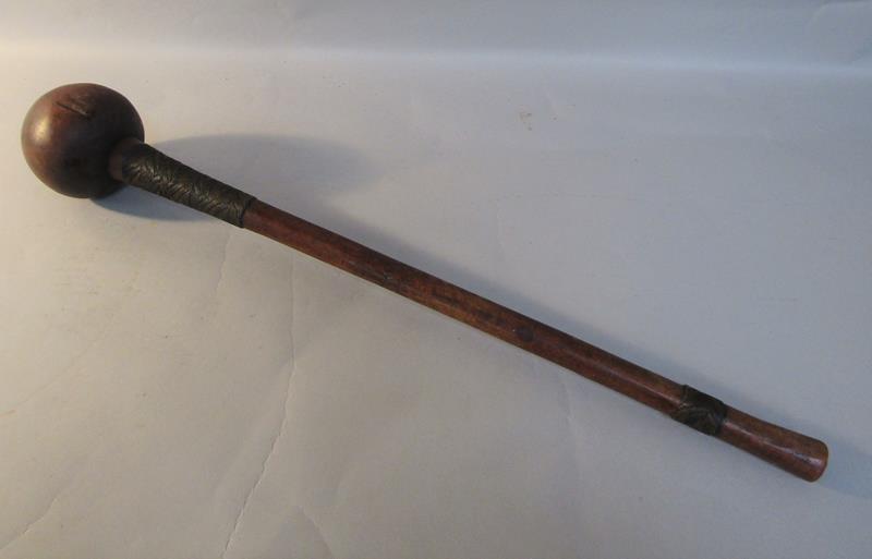 A late 19c/early 20c Zulu carved wood throwing club with ball terminal, the handle wire bound in two