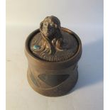 A Bretby Art Nouveau copper glazed tobacco jar and cover, the cover with female head finial,