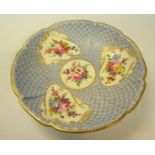 A 19c Nantgarw circular dish with four hand painted floral panels, blue dot and gilt ground,