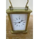 A late 19c French carriage timepiece in glazed brass 'Obis' type case with white enamel dial with