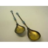 A pair of early 20c David Anderson silver and enamel cloisonne preserve type spoons, blue and