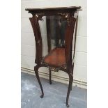 A late 19c mahogany Art Nouveau vitrine cabinet on stand, the mirrorback windowed cabinet with