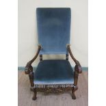 An early 18c style walnut framed and upholstered open armchair, the down swept scrolling arms with