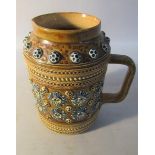 A late 19c Doulton Lambeth stoneware jug with applied and incised floral decoration and with bands