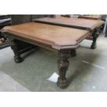A Victorian large oak extending dining table, the top with moulded edge, having an architectural