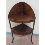 A George III mahogany corner wash stand with raised panel back over table top and having a central