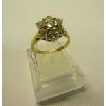 An 18ct yellow gold and platinum set diamond cluster ring of seven cut stones, approx 1.5ct, size