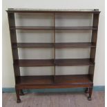 A 19c mahogany waterfall bookcase fitted six shelves with three quarter brass gallery and