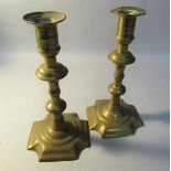 A pair of George Grove 18c petal base brass double knop three piece candlesticks, c.1765, one