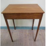 A late Regency satin wood table of rectangular form with an ebony line edging, fitted one long