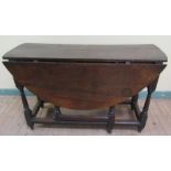 A late 17c/early 18c oak oval twin flap gateleg table fitted end drawer, supported on ring turned