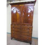 An early Victorian figured mahogany linen press, the upper section of two compartments, one having