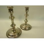 A pair of 20c, 18c style silver cased double knop candlesticks on circular stepped bases, makers
